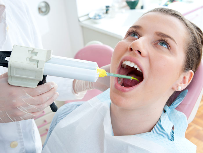 woman in dentist chair with dentist